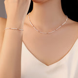 model wearing Kaia white freshwater pearl necklace band bracelet with pink gold beads stainless steel