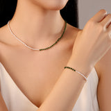 model wearing necklace with white freshwater pearls and green gold stainless steel beads
