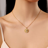 model wearing fine chain necklace with round sunburst sparkle pendant charm, waterproof stainless steel, 18k gold plated