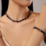 model wears jo necklace bracelet set in black pearls silver barbed wire charms