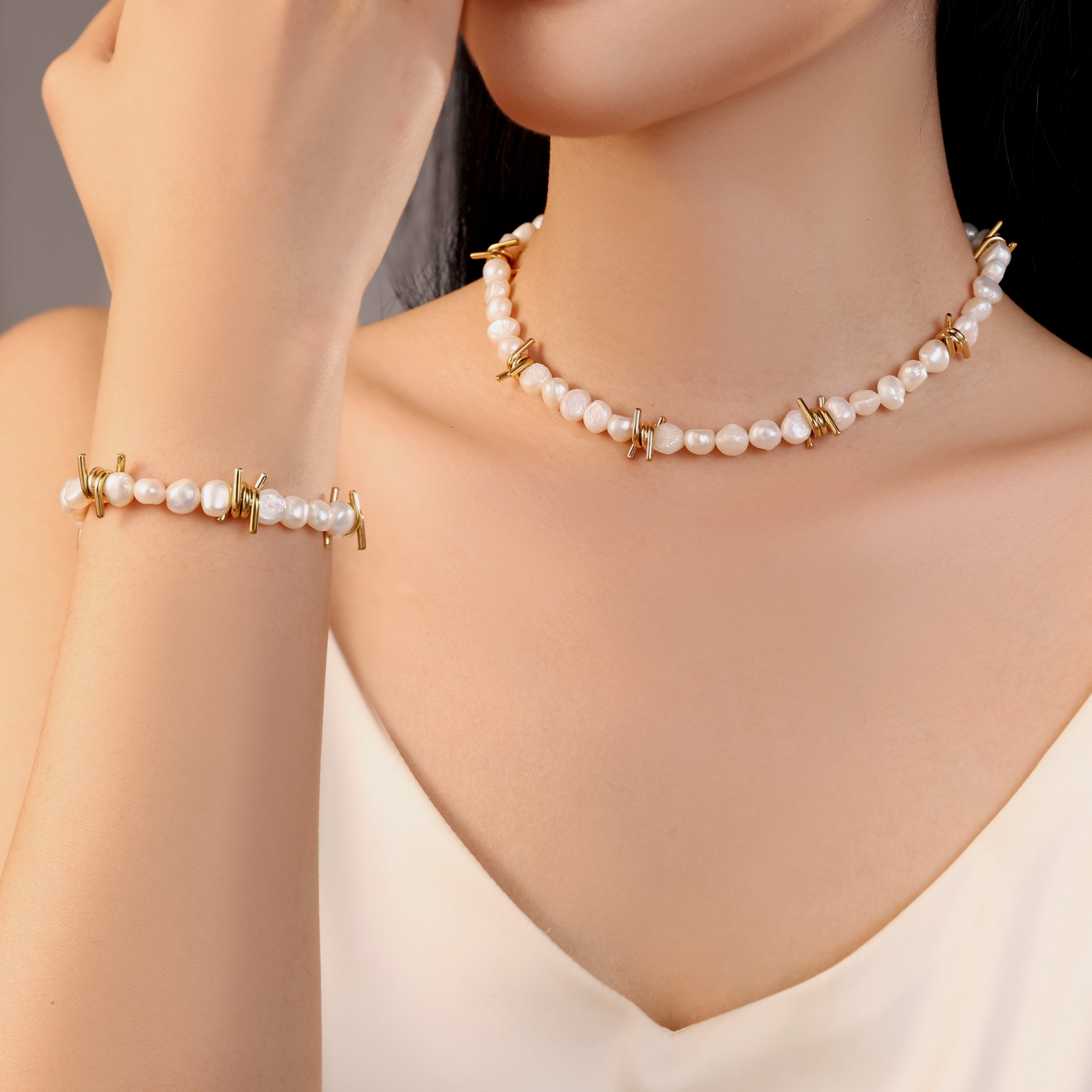 model wearing freshwater pearl necklace bracelet with gold barbed wire charms, waterproof stainless steel