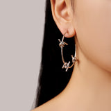 model wearing silver waterproof stainless steel barbed wire large hoop earrings
