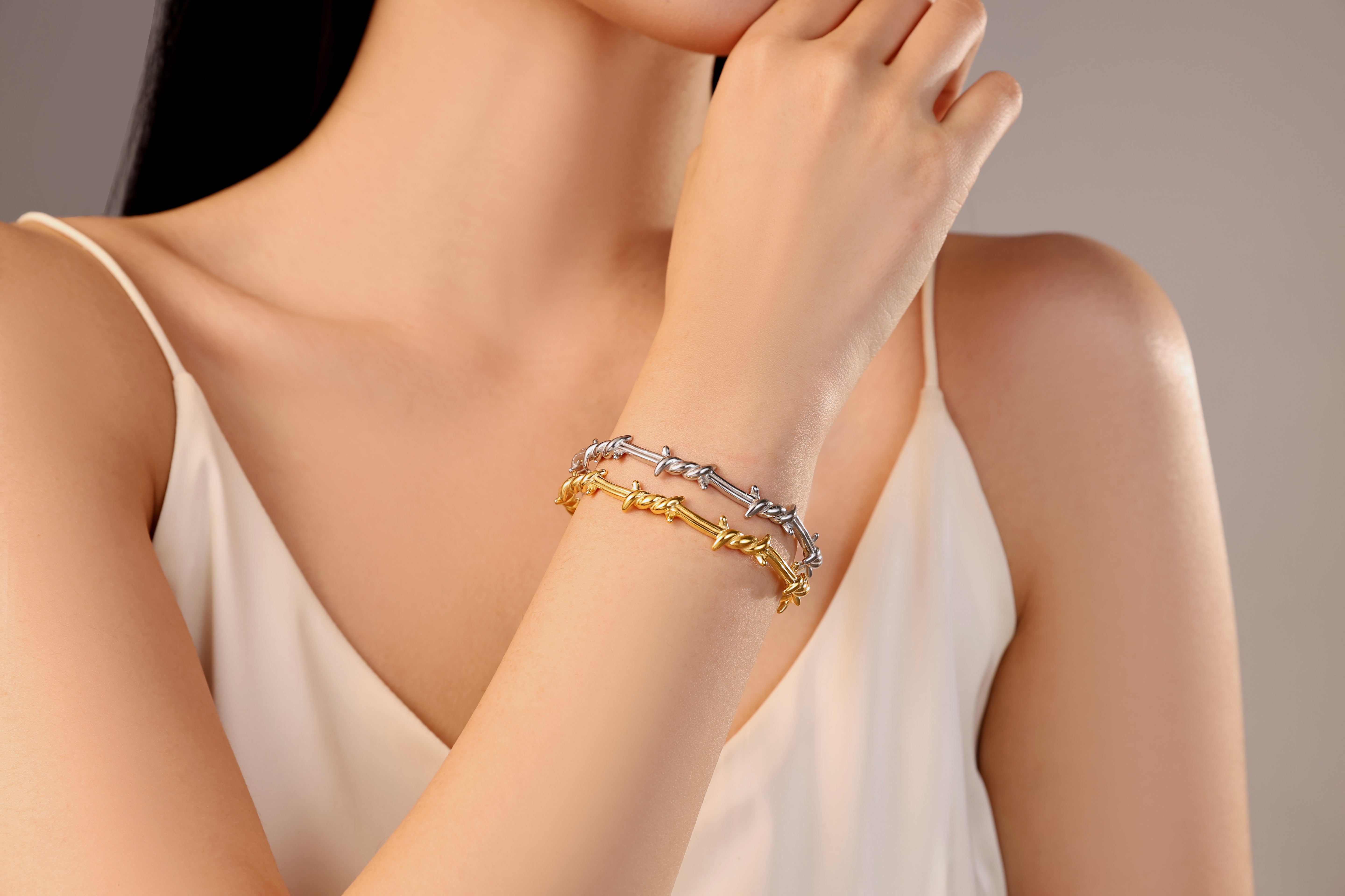 model wearing silver gold waterproof stainless steel barbed wire bangle