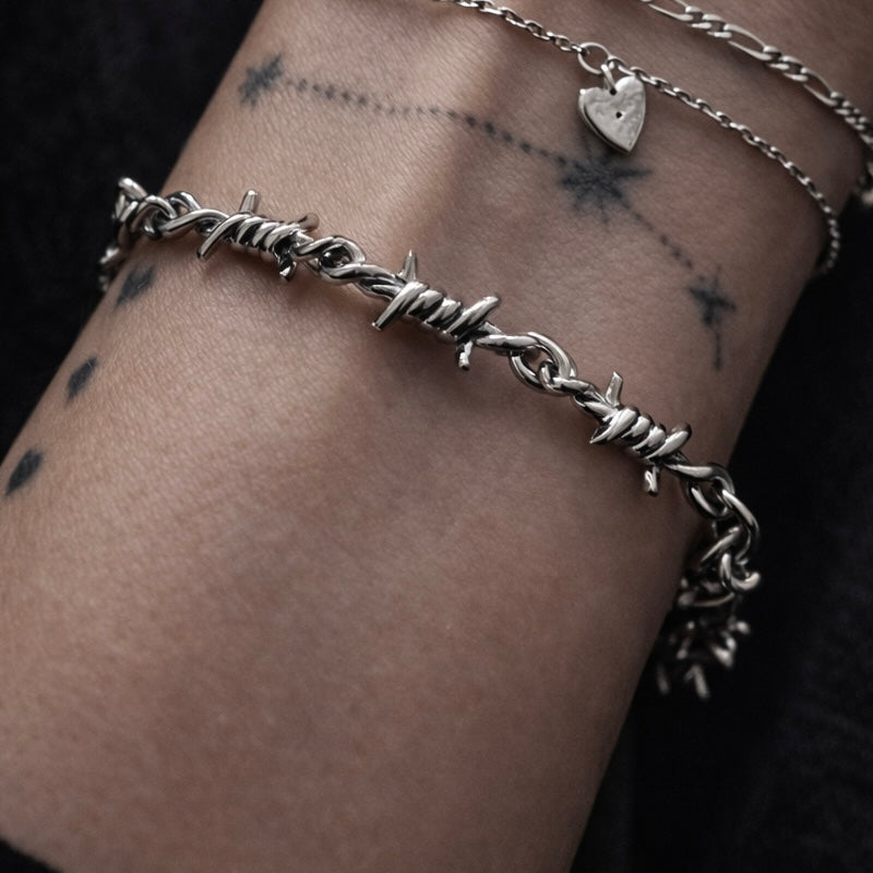Silver barbed wire bracelet on a wrist
