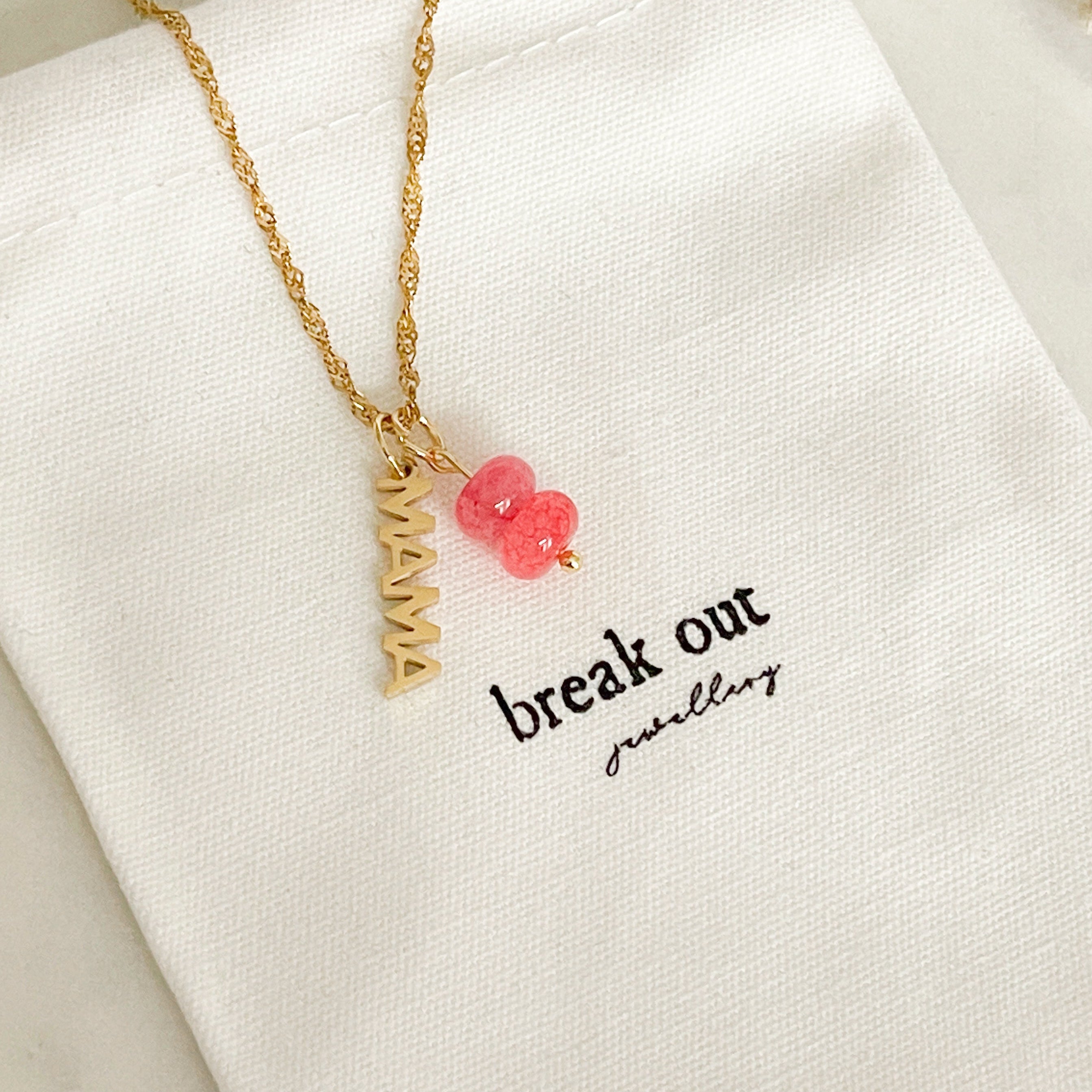 Gold necklace with mama charm and coral stone charm 