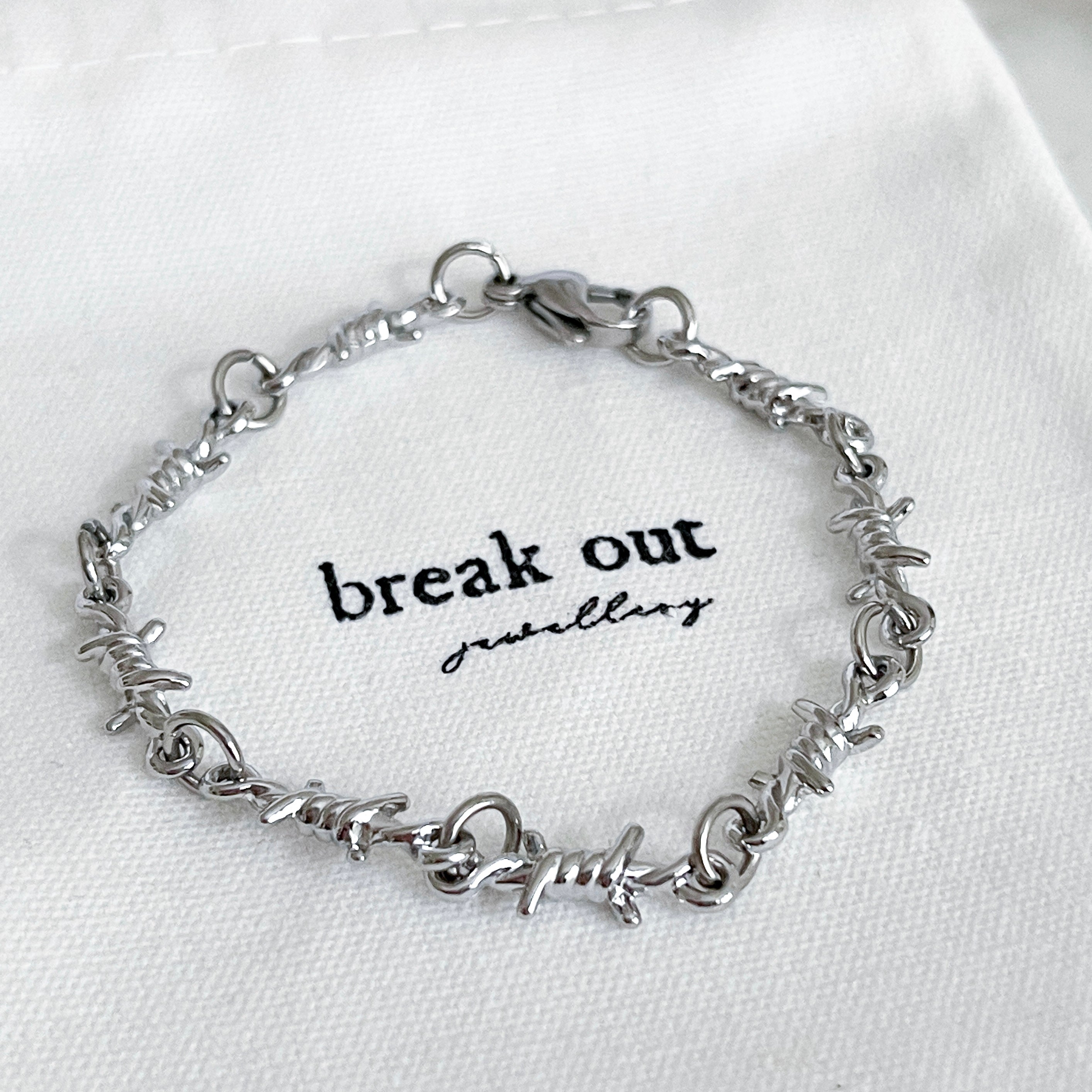 Silver bracelet on a white background with 'break out jewellery' branding.